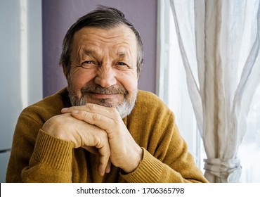 Smiling Elderly Man At Home By The Window