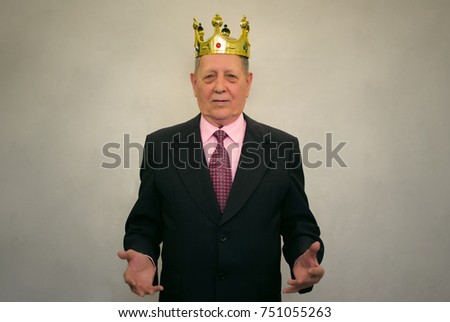 Smiling elderly senior business man in suit, tie and with golden crown above his head stretches out his arms isolated on gray background. Old king. The Royal Meeting. First person.