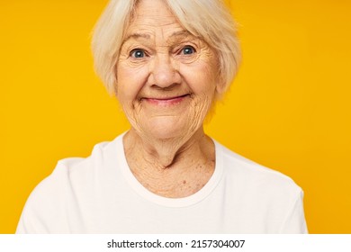 smiling elderly woman in white t-shirt posing fun isolated background - Shutterstock ID 2157304007