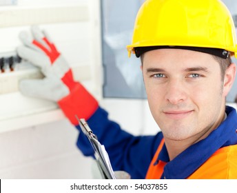 Smiling Electrician Repairing A Power Plan At Work