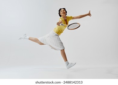 Smiling elegant woman in yellow blouse and skirt in motion, playing tennis isolated on white background. Concept of sport, retro and vintage, active lifestyle, hobby - Powered by Shutterstock