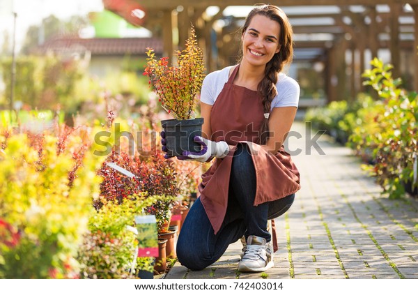 Smiling employee in garden\
center\

