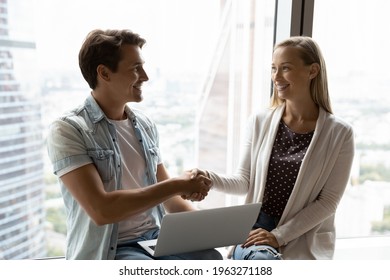 Smiling employee shake hand of job applicant or candidate after successful interview in office. Happy businesspeople handshake make agreement or get acquainted at meeting. Acquaintance concept. - Shutterstock ID 1963271188