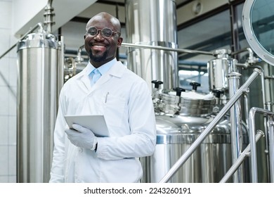 Smiling engineer working at production factory - Powered by Shutterstock