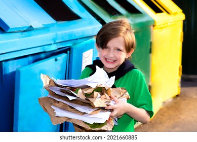 smiling european child standing at the trash can, boy is gooing to throw away sorted paper , saving the natural environment. metal trash for different garbage, an ecological approach - Shutterstock ID 2021660885