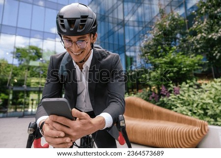 Smiling and exciting young manin hemlet having a video call