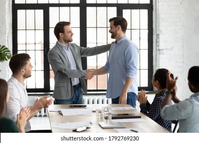 Smiling executive shaking successful employee hand, congratulating with job promotion, thanking for good work results, diverse employees applauding to colleague, appreciation and recognition - Shutterstock ID 1792769230