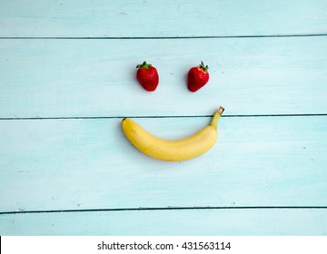 Smiling Face Made From Fruit On A Wooden Background