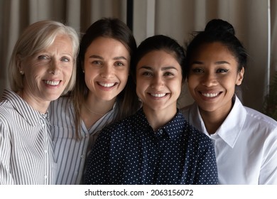 Smiling Faces Of Friendly Colleagues. Team Portrait Of Four Females Coworkers Of Different Age Ethnic Group. Happy Diverse Multiethnic Women Human Resource Of International Company Bond Look At Camera