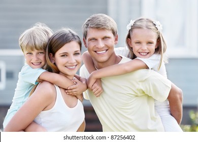 Smiling family with children outdoors
