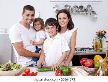 Smiling Family Cooking Together In The Kitchen