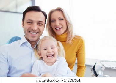 Smiling Family In A Dental Clinic