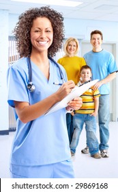 Smiling Family Medical Doctor Nurse And Young Family.