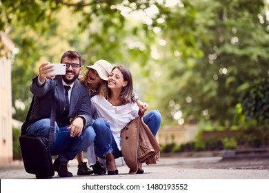 Smiling Family Taking Photo Of Them After First Day Of School