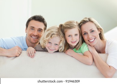 Smiling Family Together On The Couch