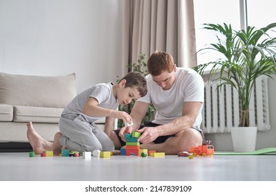 smiling father and little son playing with colorful blocks together at home. Playtime. diverse family - Powered by Shutterstock