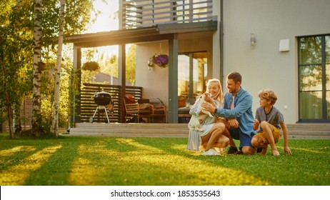 Smiling Father, Mother and Son Pet and Play with Smooth Fox Terrier Retriever Dog. Sun Shines on Idyllic Happy Family with Loyal Pedigree Dog have Fun at the Idyllic Suburban House Backyard - Shutterstock ID 1853535643