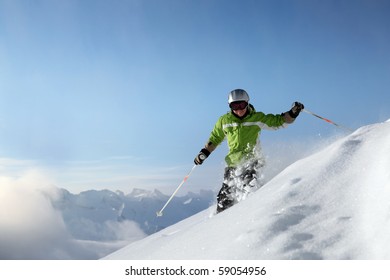 Smiling femal skiier with view to mountains in powder snow
