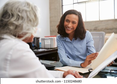 Smiling Female Analyst In Consultation With Senior Woman