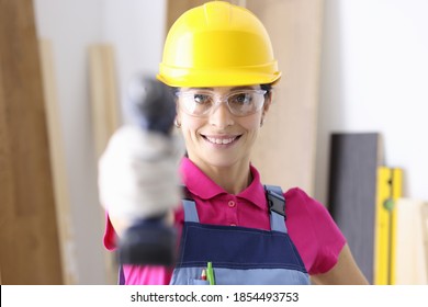 Smiling Female Builder Holding Drill. Tool Rental And Rental Concept