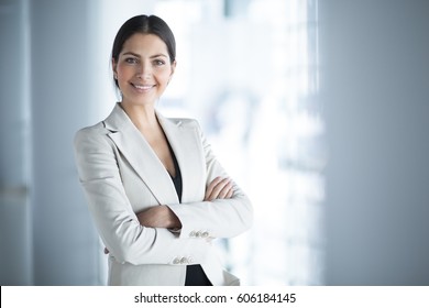Smiling Female Business Leader With Arms Crossed - Shutterstock ID 606184145