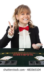 Smiling Female Casino Worker, Wearing A Black Suit With A Red Tie Holding A Deck Of Cards. White Background.