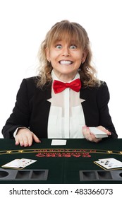 Smiling Female Casino Worker, Wearing A Black Suit With A Red Tie Holding A Deck Of Cards. White Background.