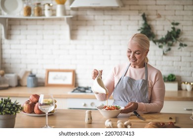 Smiling Female Cook Busy Dressing The Salad