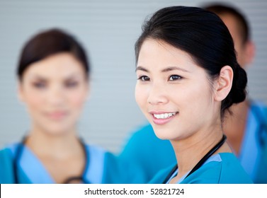 Smiling female doctor with her teamates in the hospital