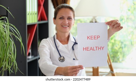 Smiling Female Doctor Is Holding Inscription Keep Healthy. Health Insurance And Patient Refusal Of Treatment