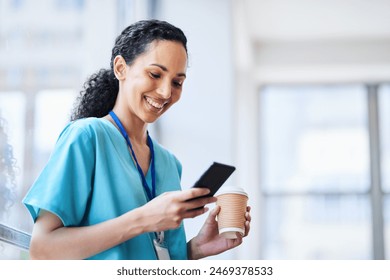 Smiling Female Doctor in Hospital Scrubs Using Smartphone with Coffee - Powered by Shutterstock