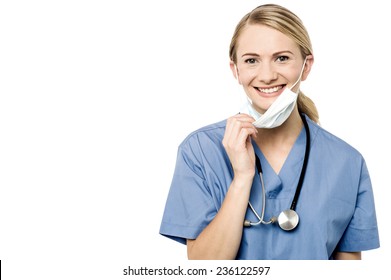 Smiling Female Doctor Removing Her Surgical Mask