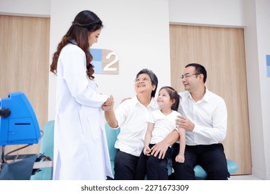 smiling female doctor Shaking hands to support the elderly woman patient. - Powered by Shutterstock