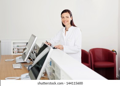 Smiling Female Doctor Standing At The Reception Desk