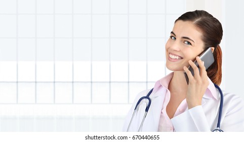 Smiling Female Doctor Talks To The Cell Phone, Concept Of Medical Worker