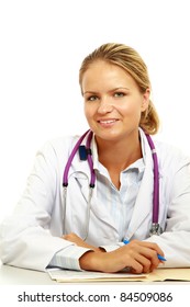 Smiling Female Doctor Working At Desk, Isolated On White