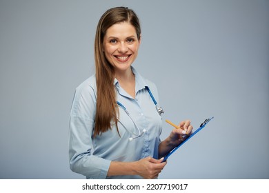 Smiling Female Doctor Writing On A Tablet. Isolated Portrait Of Doctor Woman.