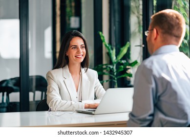 Smiling Female Financial Adviser Talking With A Customer.