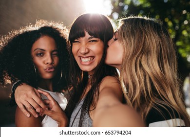 Smiling Female Friends Hanging Out Together And Taking Selfie. Multi Ethnic Group Of Women Outdoors In The City And Taking Self Portrait.