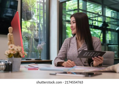 Smiling Female Graphic Designer Working With New Startup Project In Modern Office.