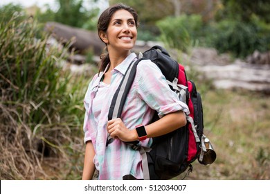 Smiling Female Hiker Hiking In Forest