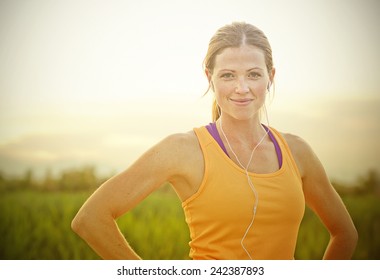 Smiling Female Jogger at Sunset (intentional sun glare) - Powered by Shutterstock