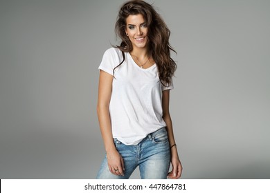 Smiling female model isolated on grey background
