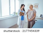 Smiling female patient at consultation with woman doctor. Patient Having Consultation With Doctor In Office. Cropped shot of a medical practitioner reassuring a patient