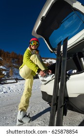 Smiling Female Skier Putting Her Ski Boots On