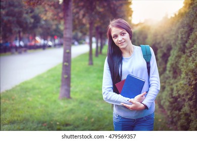 Smiling female student showing thumb up - Shutterstock ID 479569357