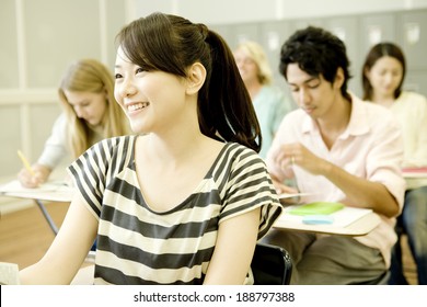 smiling female student studying in classroom