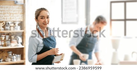Smiling female waitress wear apron ready to take order on notepad in restaurant, serving staff good customer service