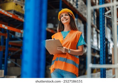 Smiling female warehouse worker in safety gear checks inventory on a clipboard, ensuring smooth operations. Organized shelves reflect her dedication to managing merchandise - Powered by Shutterstock