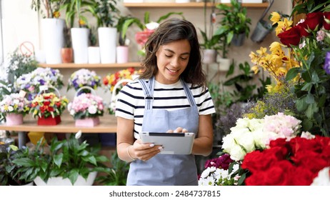 Smiling florist enjoying while running her business - Powered by Shutterstock